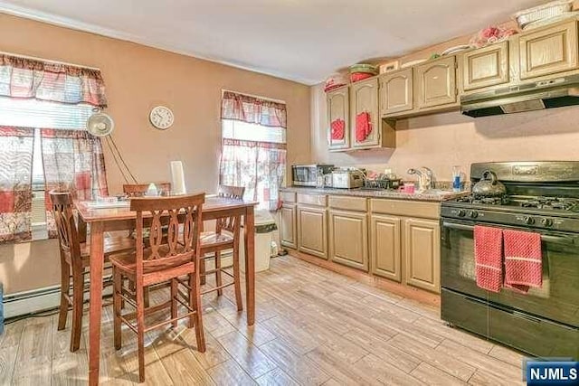 kitchen featuring black range with gas stovetop, sink, and light hardwood / wood-style flooring