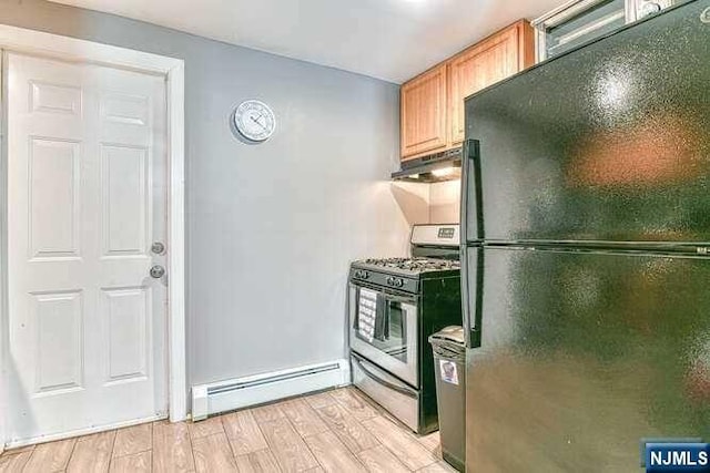 kitchen featuring gas stove, black refrigerator, a baseboard radiator, and light hardwood / wood-style flooring