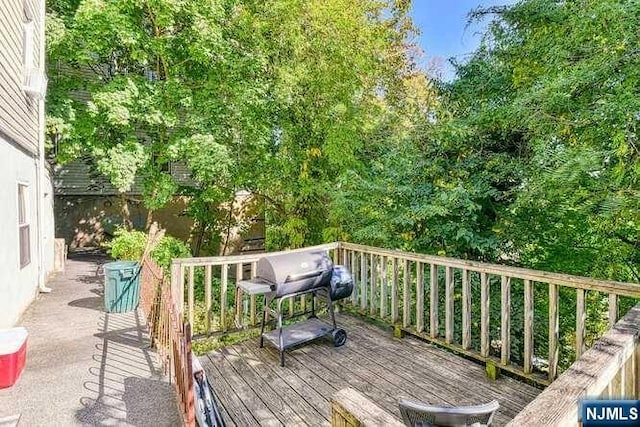 wooden deck featuring area for grilling