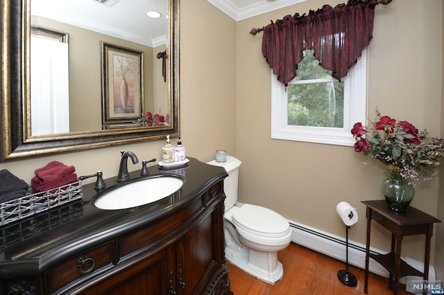 bathroom featuring vanity, a baseboard heating unit, crown molding, toilet, and wood-type flooring