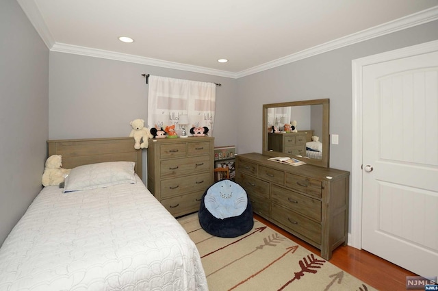 bedroom with hardwood / wood-style flooring and crown molding