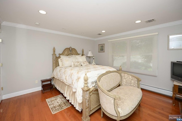 bedroom with crown molding, dark wood-type flooring, and a baseboard heating unit