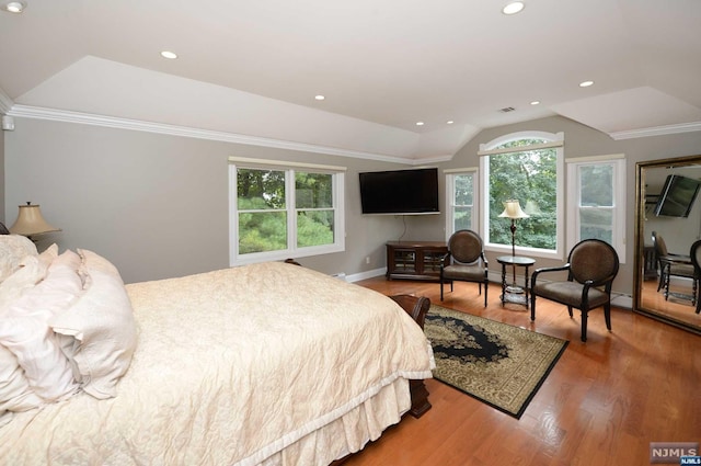 bedroom featuring hardwood / wood-style flooring, lofted ceiling, ornamental molding, and baseboard heating