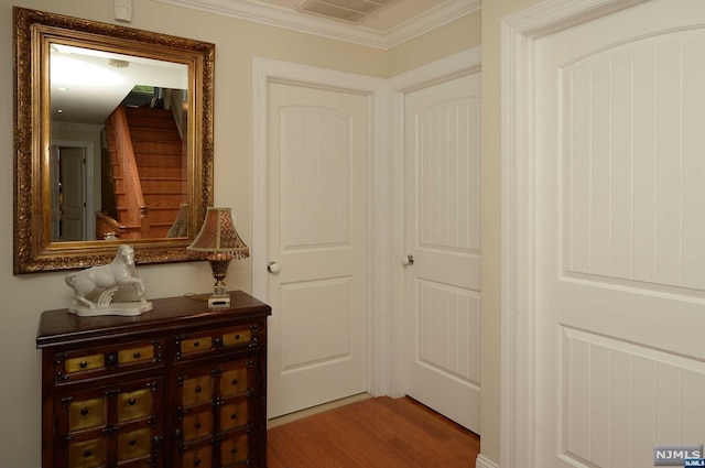 corridor featuring hardwood / wood-style floors and ornamental molding