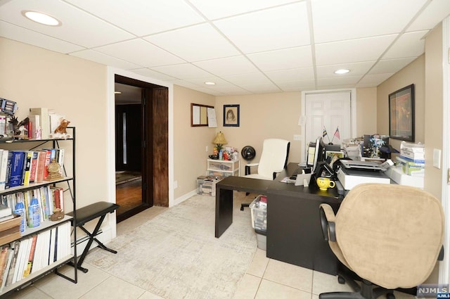 office with a drop ceiling and light tile patterned floors