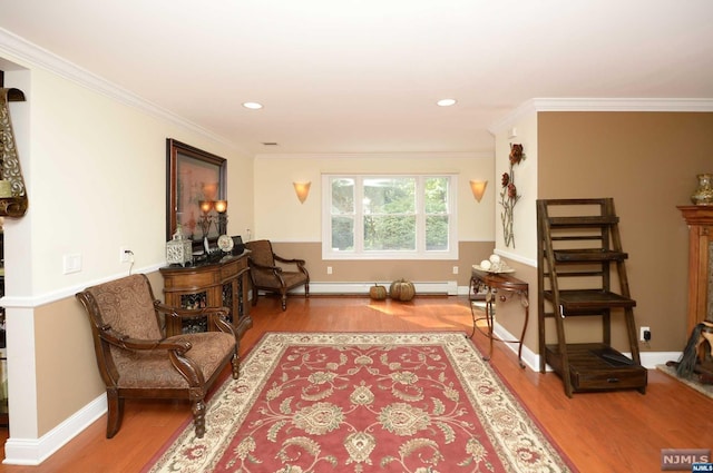 living area with hardwood / wood-style flooring and ornamental molding