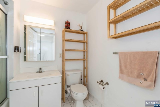 bathroom featuring tile patterned floors, vanity, and toilet