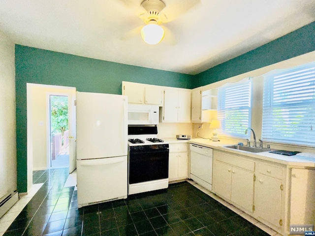 kitchen with white appliances, ceiling fan, baseboard heating, sink, and white cabinets