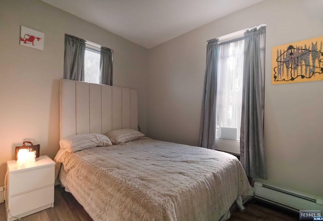 bedroom featuring dark hardwood / wood-style floors and a baseboard radiator