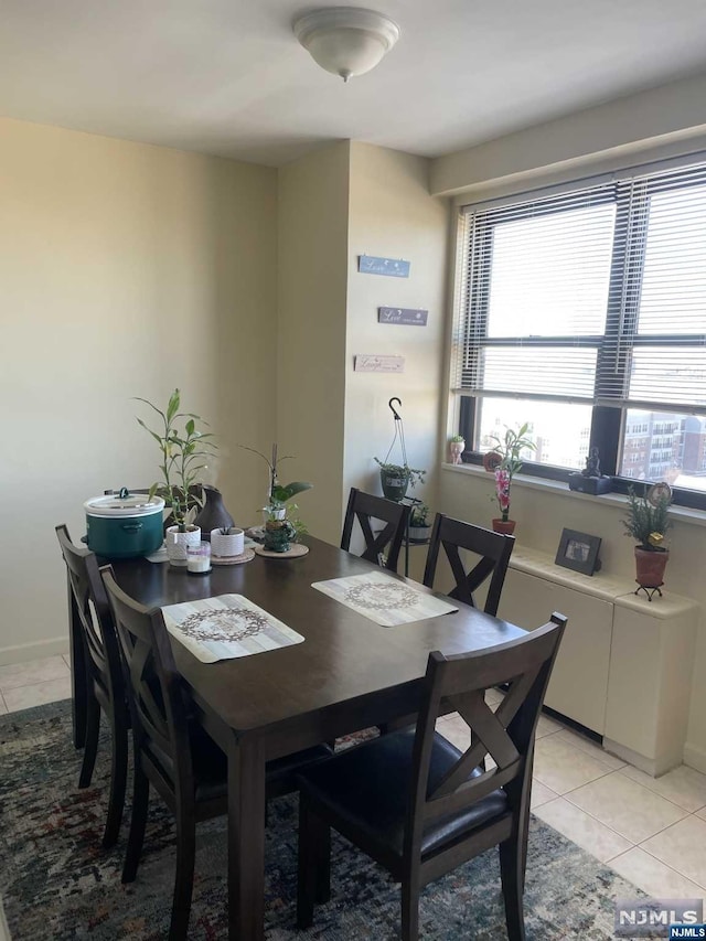 dining space featuring a healthy amount of sunlight and light tile patterned floors