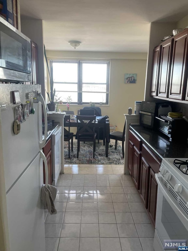 kitchen with light tile patterned floors and white appliances