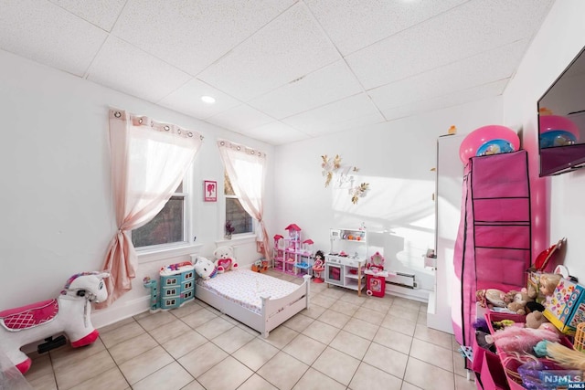 playroom featuring tile patterned flooring and a drop ceiling