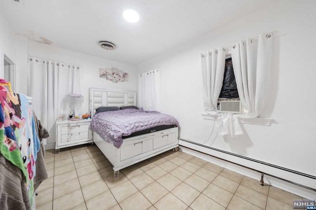 bedroom featuring light tile patterned floors, cooling unit, and a baseboard heating unit