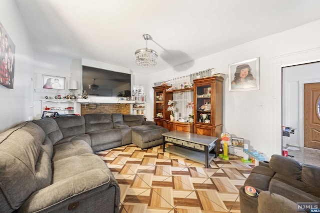 living room with an inviting chandelier and light parquet flooring