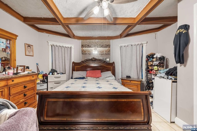 bedroom featuring ceiling fan, coffered ceiling, light tile patterned flooring, and a textured ceiling