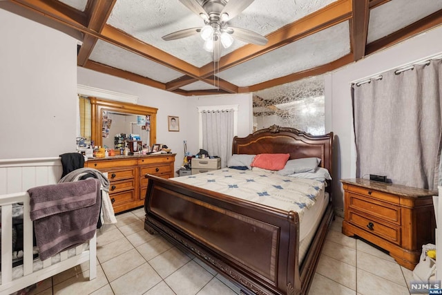 bedroom featuring ceiling fan, light tile patterned flooring, and a textured ceiling