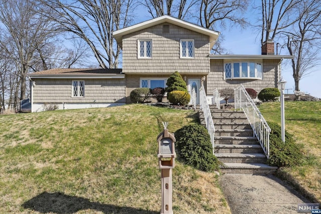 split level home with a front lawn