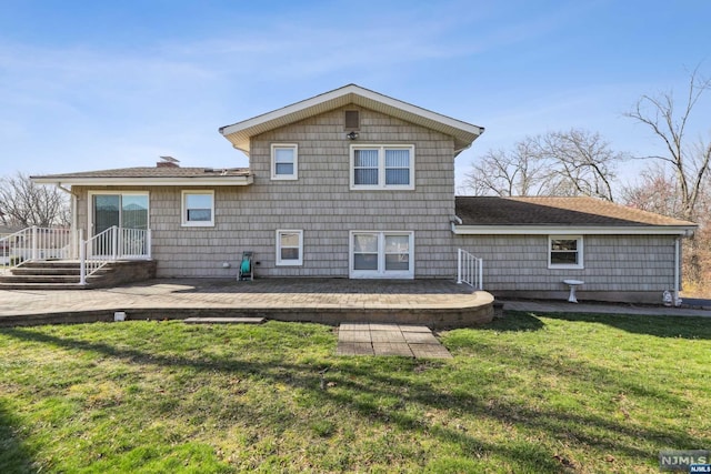 rear view of house featuring a lawn