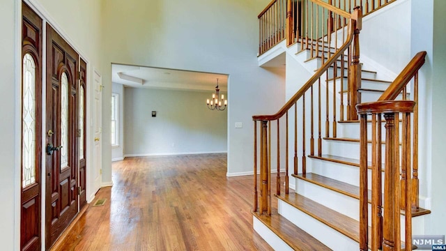 entryway with a chandelier and hardwood / wood-style flooring