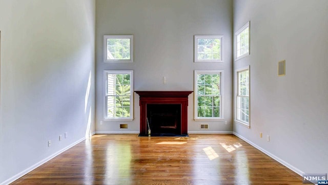 unfurnished living room featuring a healthy amount of sunlight and light hardwood / wood-style flooring