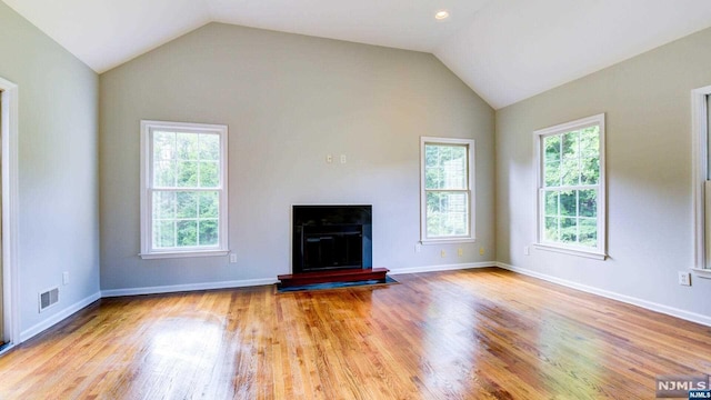 unfurnished living room featuring light hardwood / wood-style floors and lofted ceiling