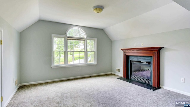 unfurnished living room with lofted ceiling and carpet floors