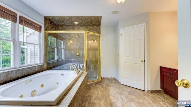 bathroom with vanity and independent shower and bath