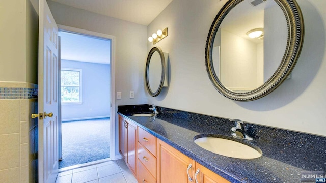 bathroom featuring tile patterned flooring and vanity