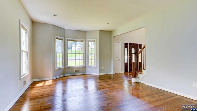 spare room featuring wood-type flooring