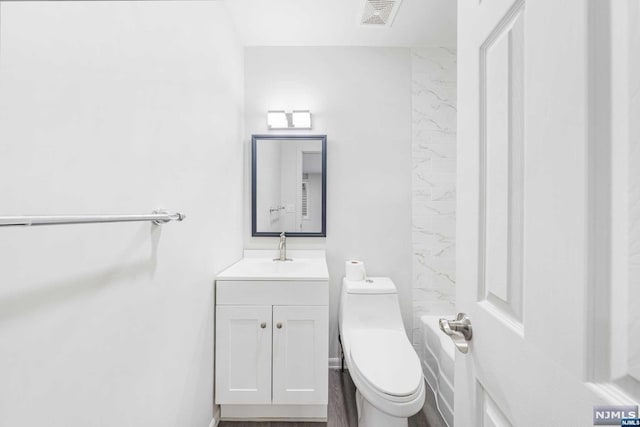 bathroom featuring vanity and toilet