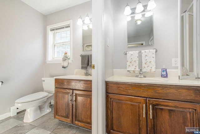 bathroom featuring tile patterned flooring, vanity, and toilet