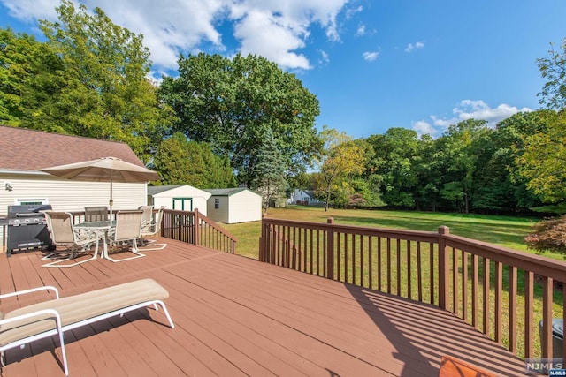 deck with an outbuilding and a lawn