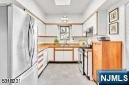 kitchen featuring sink, white cabinets, and stainless steel appliances