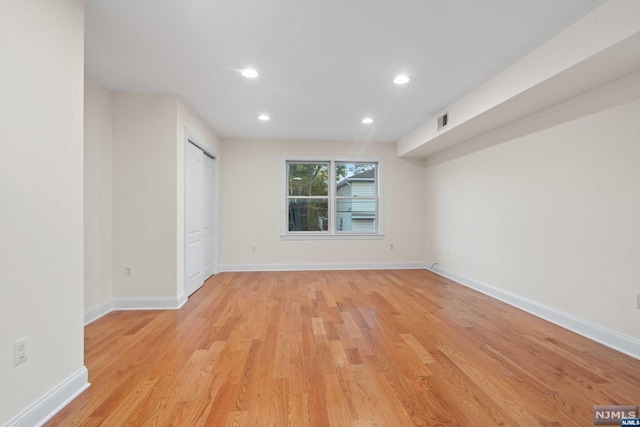 empty room with light hardwood / wood-style flooring