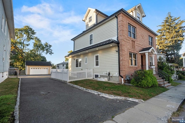 view of front of home with an outbuilding and a garage