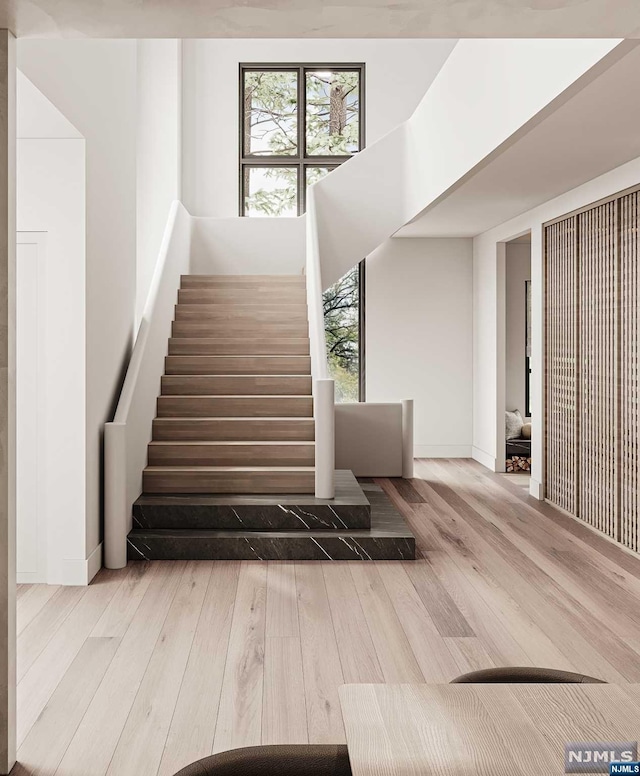 staircase with hardwood / wood-style floors