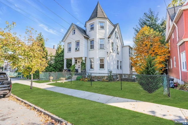 victorian-style house with a front yard