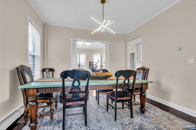 dining space featuring hardwood / wood-style floors, plenty of natural light, baseboard heating, and a notable chandelier