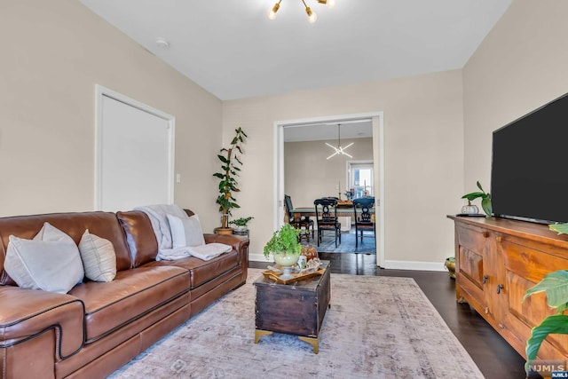 living room featuring dark hardwood / wood-style flooring and a chandelier