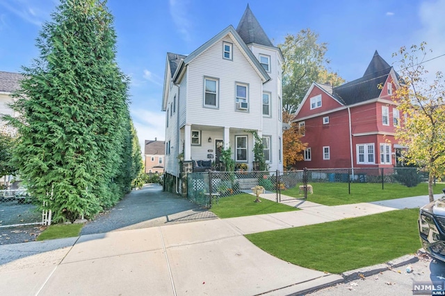 victorian house featuring a front yard