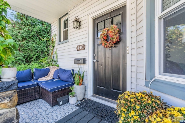 view of exterior entry with covered porch