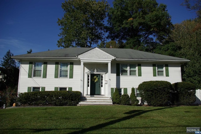 raised ranch with a front lawn