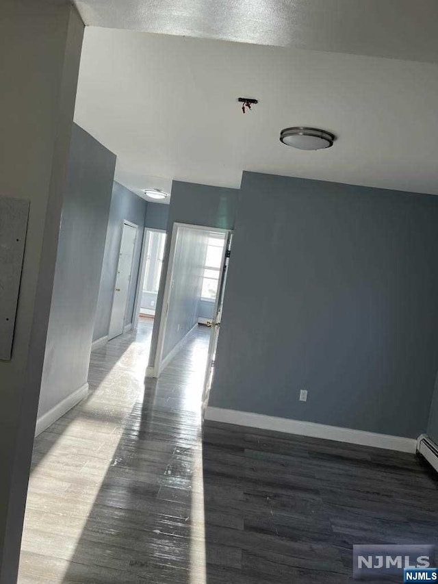 unfurnished room featuring hardwood / wood-style flooring