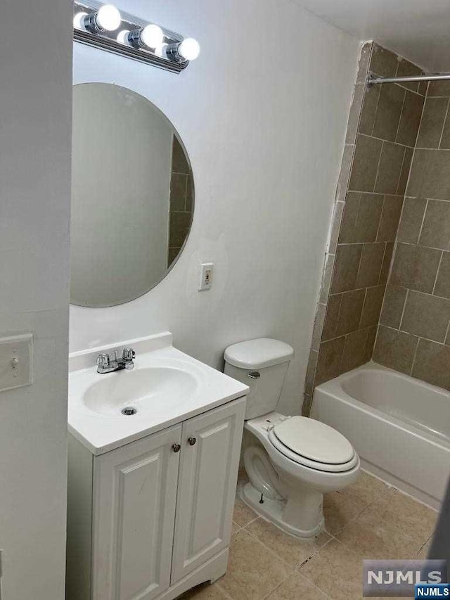 full bathroom with tile patterned floors, vanity, toilet, and tiled shower / bath