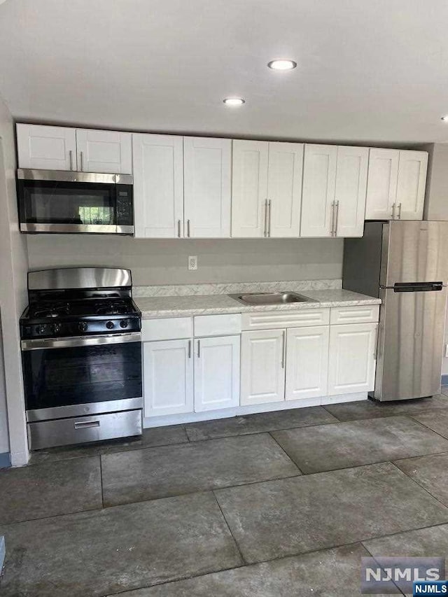 kitchen featuring white cabinets, sink, and stainless steel appliances