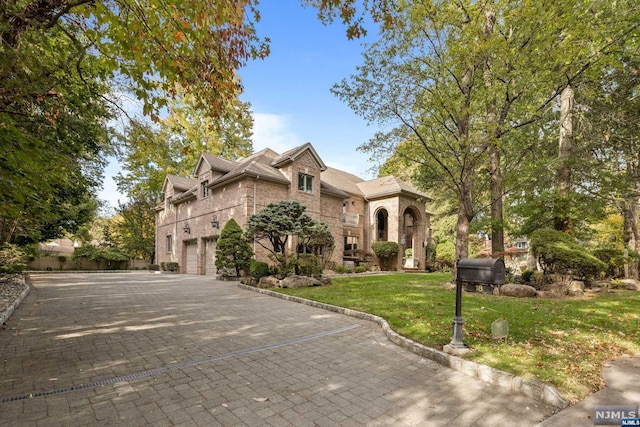 view of front of home with a garage and a front lawn