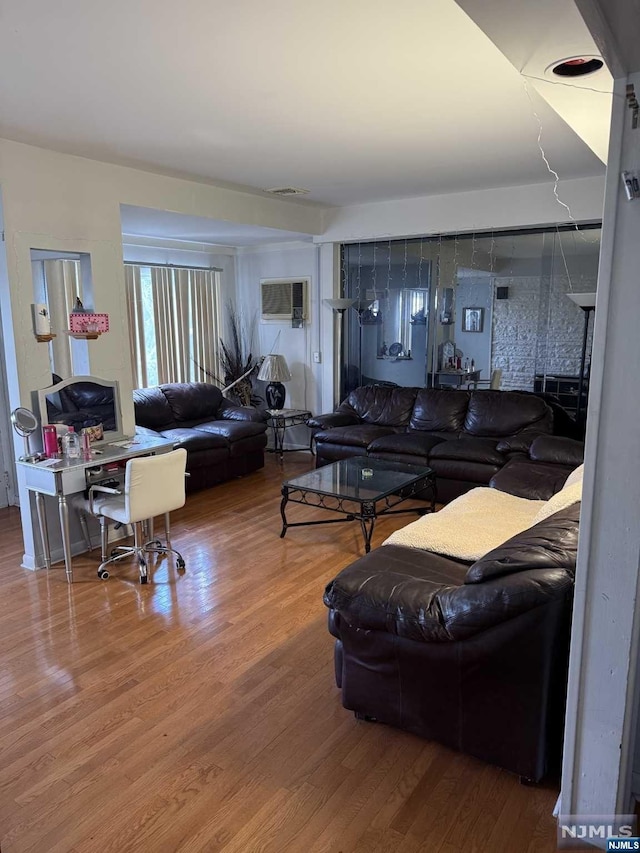 living room with wood-type flooring and a wall mounted AC