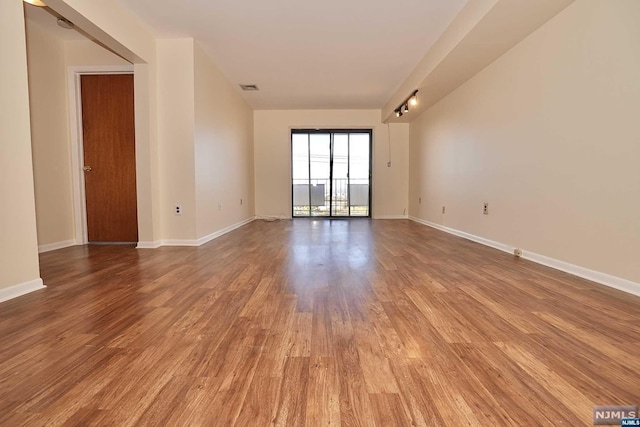 spare room with wood-type flooring