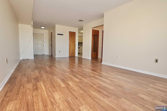 spare room featuring light hardwood / wood-style floors