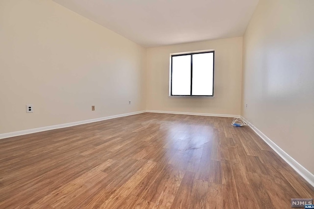 unfurnished room featuring hardwood / wood-style floors